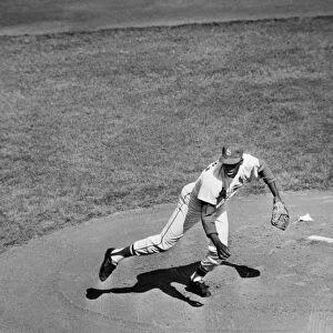 BOB GIBSON (1935- ). American baseball pitcher. Pitching the St. Louis Cardinals to victory over the New York Yankees in the seventh and deciding game of the 1964 World Series, at Busch Stadium, St. Louis, Missouri, 15 October 1964