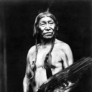 BOBTAILHORSE, c1913. Bobtailhorse, a Blackfoot Native American, photographed holding a large bird wing, c1913
