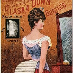 BUSTLE POSTER, 1890. American chromolithograph poster for the Improved Genuine Alaska Down Bustle, 1890