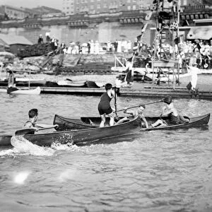 CANOE TILTING, c1910. A canoe tilting competition at the Colonial Yacht Club in America