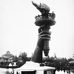 CENTENNIAL FAIR, 1876. The hand of the Statue of Liberty exhibited at the Centennial Exposition in Philadelphia, Pennsylvania, 1776. The sculptor, FrÔÇÜ dÔÇÜ ric Bartholdi, poses alongside the flame