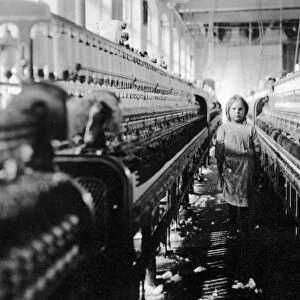 CHILD LABOR, 1908. A girl working as a spinner at a textile mill in Newberry, South Carolina