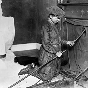 CHIMNEY SWEEP. A female chimney sweep at work