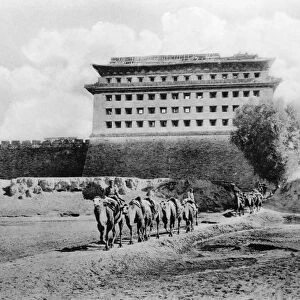 CHINA: CARAVAN, c1900. Camel caravan in front of a fort near Beijing, China, c1900