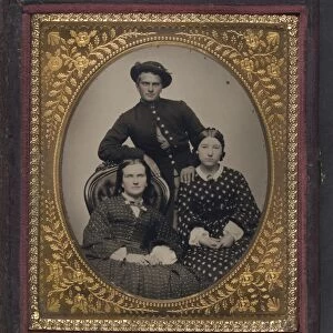 CIVIL WAR: SOLDIER, c1863. Portrait of a Union soldier and two women. Tintype, c1863