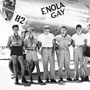 Colonel Paul W. Tibbets (center) and ground crew of the B-29 Enola Gay which dropped the first atomic bomb on Hiroshima, Japan, at the end of World War II, 6 August 1945