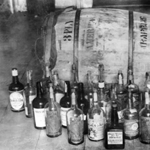 CONFISCATED WHISKEY, 1920s. Bottles and keg of whiskey confiscated during Prohibition in America
