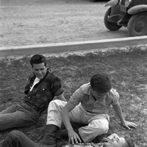 COUNTY FAIR, 1942. Teenage boys lounging on the grass at the Imperial County Fair