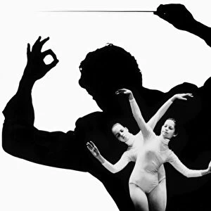 DANCER AND CONDUCTOR. Composite photograph of a young ballet dancer against a silhouette of an orchestra conductor, 1970s