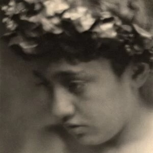 DAY: NUDE WITH LAURELS. Portrait of a nude boy wearing a laurel wreath. Photograph by F