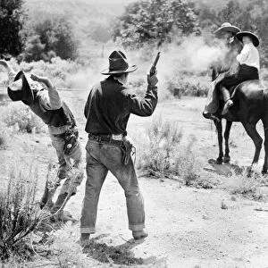 FILM: HIGHWAYMAN, c1926. Western film still of a shootout between actor Jack Hoxie with actress Helen Holmes on horseback, and two men on foot. Stereograph, c1926