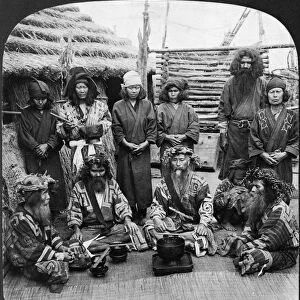 A group of Ainu men dressed in feast attire, Island of Yezo, Japan. Stereograph, c1906