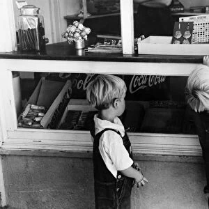 IDAHO: CHILDREN, 1941. Young boys buying candy, Caldwell, Idaho. Photograph by Russell Lee