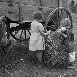 IOWA: CHILDREN, 1936. The daughters of Earl Pauley playing with dolls in a tumbleweed