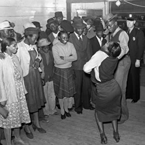 JITTERBUG DANCERS, 1939. Jitterbug dancers and a police officer in the doorway at a juke joint