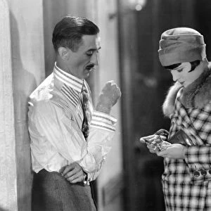 LOUISE BROOKS (1906-1985). American cinemactress. Brooks with Osgood Perkins in a scene from Love Em and Leave Em, Paramount, 1926
