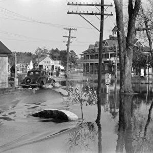 MAINE: FLOOD, 1936. Sebago Lake flooding the highway in Maine. Photograph by Paul Carter