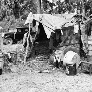 MIGRANT WORKER, 1939. A migrant workers shack in a shanty town, near Canal Point, Florida