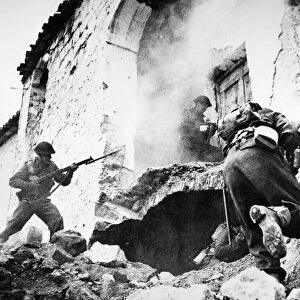 MONTE CASSINO, 1944. New Zealand soldiers search a demolished house for snipers at Cassino, Italy, during World War II. Photographed January 1944