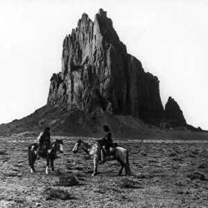 NEW MEXICO: SHIPROCK, c1914. Two Navajos on horseback in front of the Shiprock