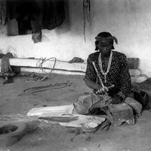 NEW MEXICO: ZUNI JEWELER. A Zuni turquoise driller at work at the Acoma pueblo