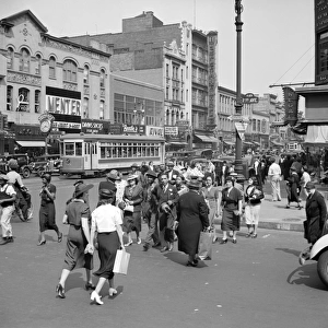 NEW YORK CITY, 1938. Street scene on 125th Street and 7th Avenue in New York City