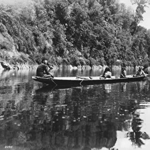 NEW ZEALAND, c1920. Maori people canoeing, probably on the Wanganui River, in New Zealand