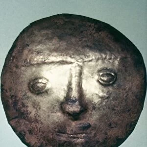 PERU: CHIMU BRONZE DISC. Hammered bronze disc with a human face in relief, made by the Chimu culture in Chan Chan, Peru, 13th-16th century