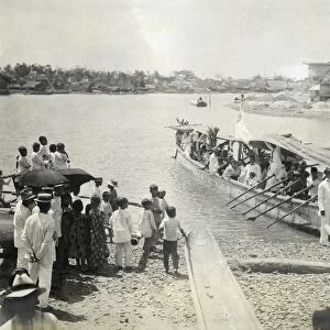 PHILIPPINES, c1900. A group of men and women boarding a boat in the Philippines