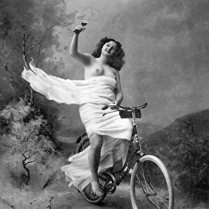 ONE FOR THE ROAD, c1900. Nude on a bicycle