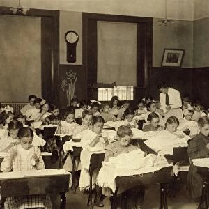SEWING CLASS, 1909. Working girls learning sewing at the Vocational Hancock School in Boston