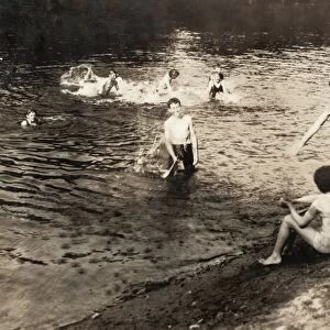 SWIMMING HOLE, 1916. A group of teenage boys at a swimming hole after a day of