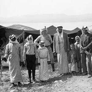 SYRIA: BEDOUINS, c1936. Group of Bedouins and a European man at a camp at Gamla
