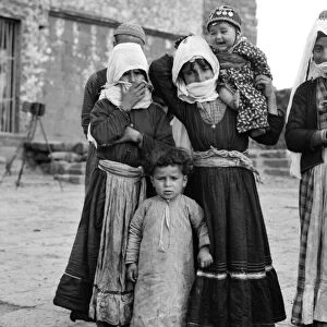 SYRIA: DRUZE WOMEN, 1938. Druze women and children on the street in Qanawat, Syria
