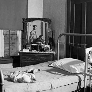 TENEMENT BEDROOM, 1940. The bedroom of a family living in a crowded slum tenement