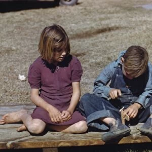 TEXAS: FSA LABOR CAMP, 1942. Boy building a model airplane while his sister watches