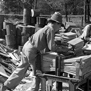 TEXAS: SAW MILL, 1939. A young boy packing roof shingles at small saw mill near Jefferson, Texas