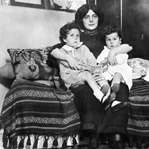 TITANIC: SURVIVORS, 1912. Young survivors of the Titanic Louis (left) and Michel Navratil on their mothers lap after being reuinted. Photographed 1912