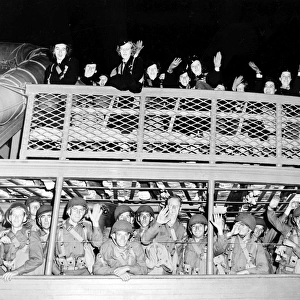 U. S. Army nurses and soldiers waving farewell as a ship leaves an American pier. Photograph, c1942