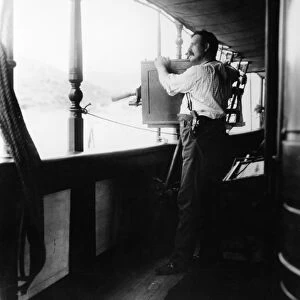 WAR PHOTOGRAPHY, 1898. A Biograph motion picture operator filming from the deck