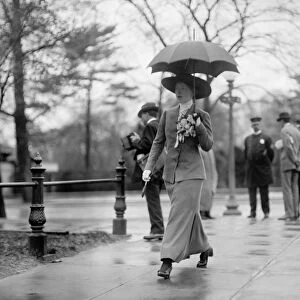 WOMAN, c1913. A woman carrying an umbrella, possibly in Washington, D. C. Photograph