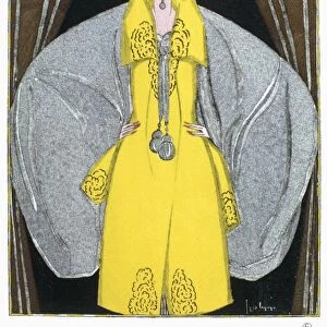 WOMENs FASHION, 1920. A woman wearing an evening coat designed by Paul Poiret
