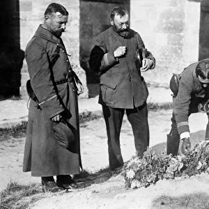 WORLD WAR I: GRAVES, 1914. French officers laying flowers on graves of soldiers