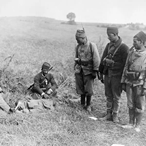 WWI: WOUNDED SOLDIER. French Moroccan soldiers caring for a wounded German soldier in France