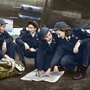 WWII: WOMEN PILOTS, c1941. Four female pilots looking at a chart. Photograph, c1941