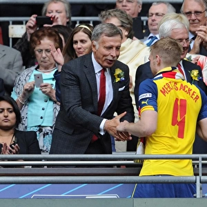 Arsenal Director Stan Kroenke shakes hands with Per Mertesacker (Arsenal) after the match
