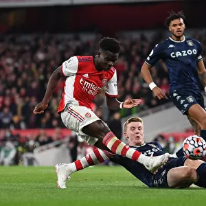 Arsenal's Bukayo Saka Faces Off Against Matt Targett in Intense Arsenal v Aston Villa Clash