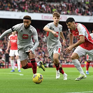 Arsenal's Martinelli Clashes with Sheffield United's Bogle: Premier League Showdown at Emirates Stadium (2023-24)