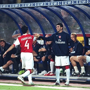 Cesc Fabregas celebrates scoring the 1st Arsenal goal with Jose Reyas