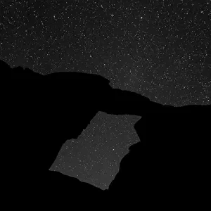 A night-time picture of a natural arch at Wadi Rum, Jordan
